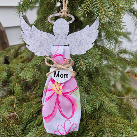 Angel wings with a printed pattern and glitter halo (not real glitter) holds fabric of a loved one