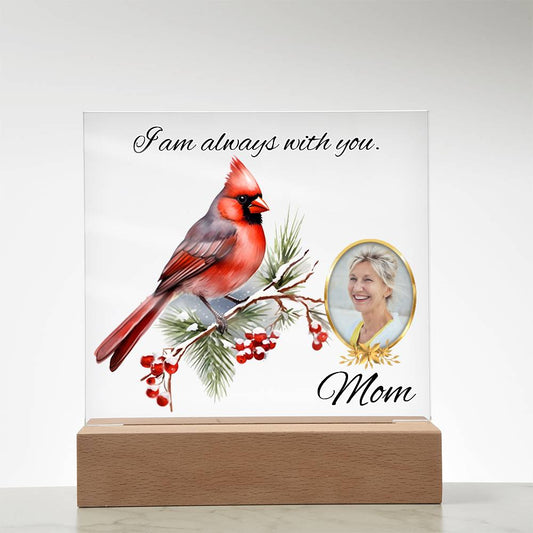 a glass block with a picture of a cardinal and a picture of a woman